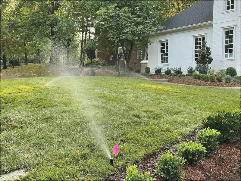 Sprinklers running on a fresh green lawn at spring startup